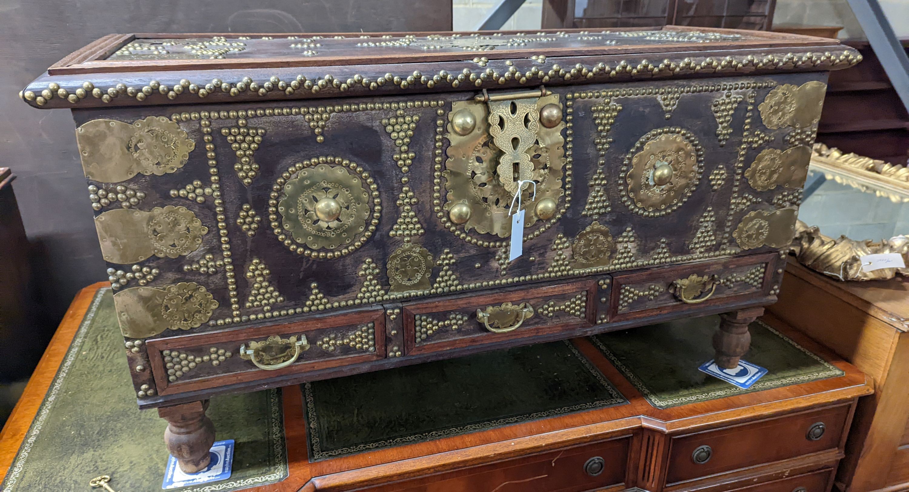 An Eastern brass mounted and studded hardwood trunk, length 113cm, depth 48cm, height 60cm